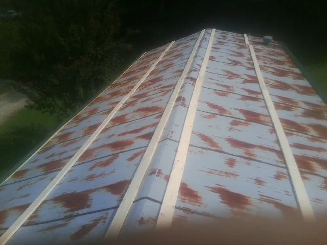 Rusted metal roof panels with new wood purlins before replacement — Storm Damage Roof Repair in Imlay by Roofing Brothers